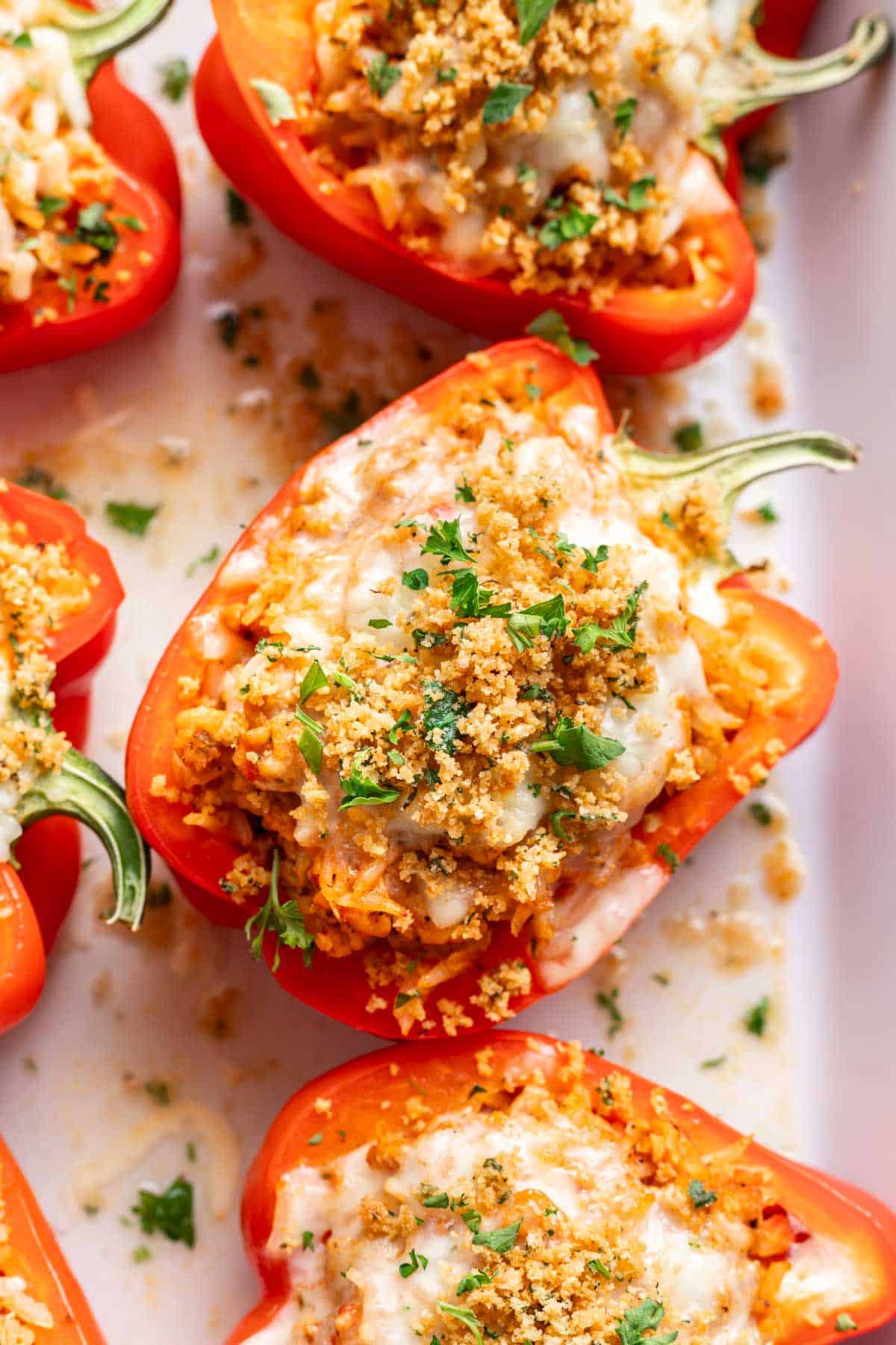 Chicken parmesan stuffed peppers with mozzarella cheese and toasted breadcrumbs on top.