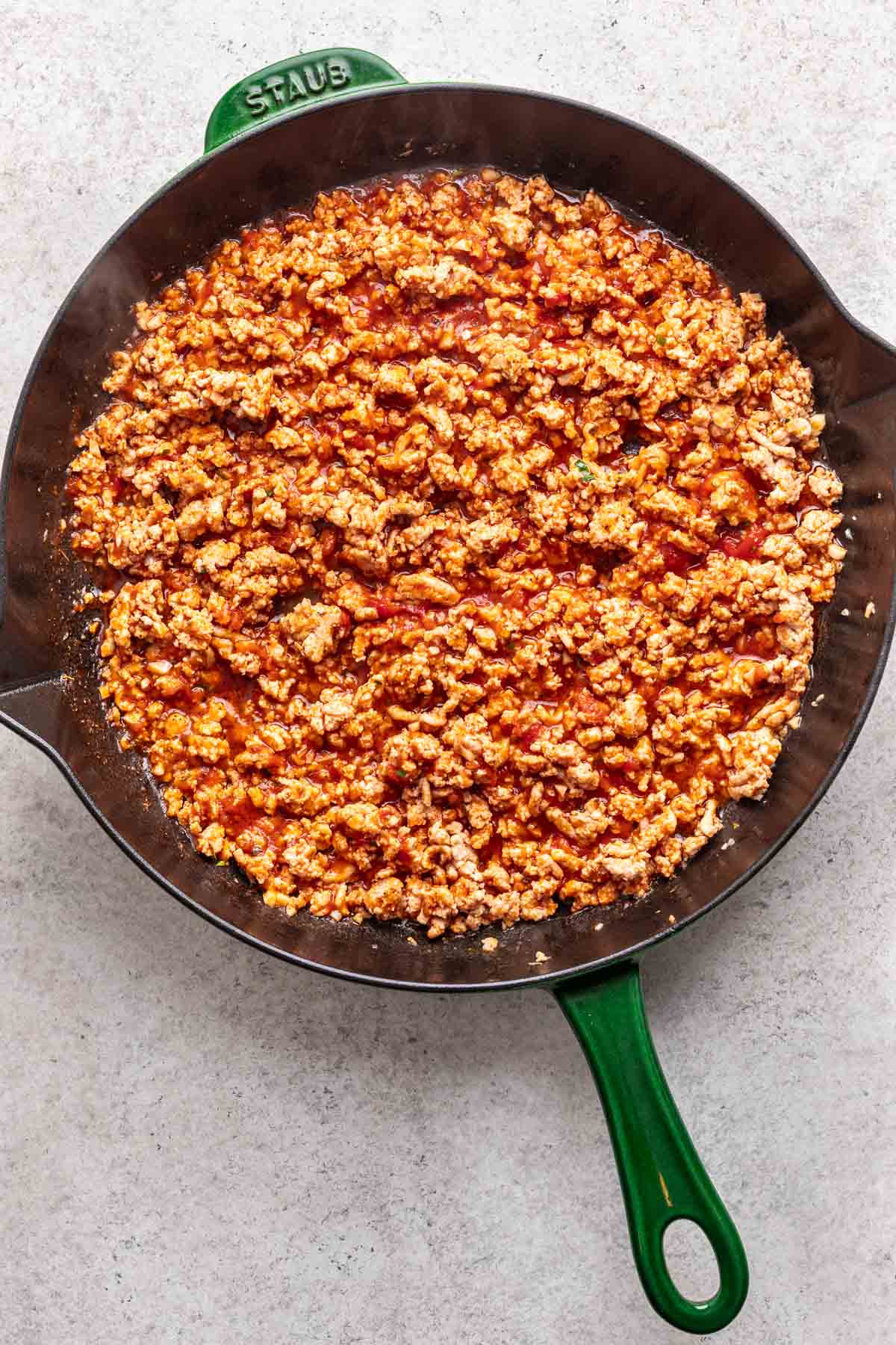 Tomato sauce and seasonings added to the ground chicken.