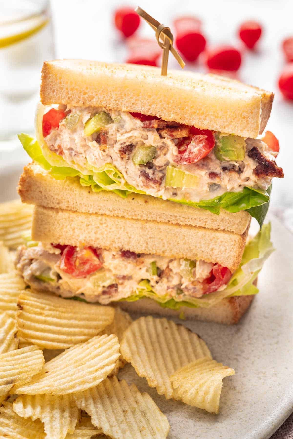 Avocado BLT chicken salad on toasted bread with lettuce.