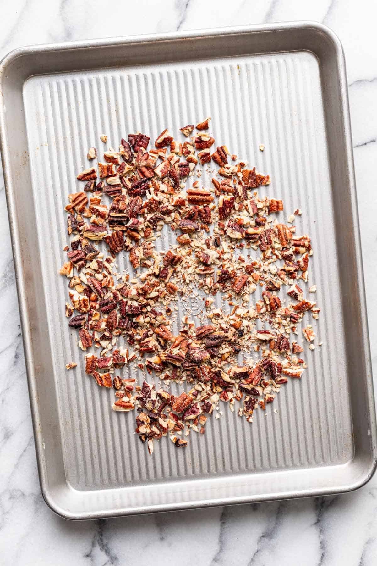 Pecans toasted on a baking sheet.