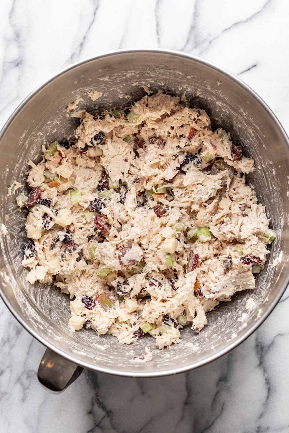 Mayonnaise and dijon mixed into shredded chicken, apples, celery, pecans, grapes, and cranberries.