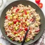 Avocado BLT chicken salad in a green bowl with a serving spoon.