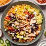 Chicken fajita bowl with all the toppings in a green bowl.