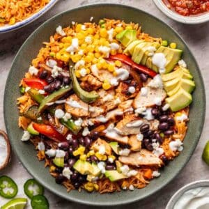 Chicken fajita bowl with all the toppings in a green bowl.
