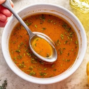 Fall pumpkin salad dressing in a white bowl with a serving spoon.