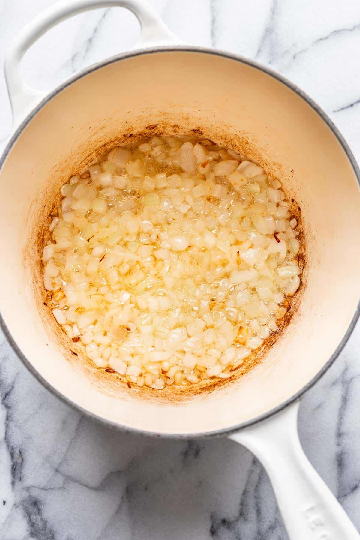 Onions sautéed in a saucepan.