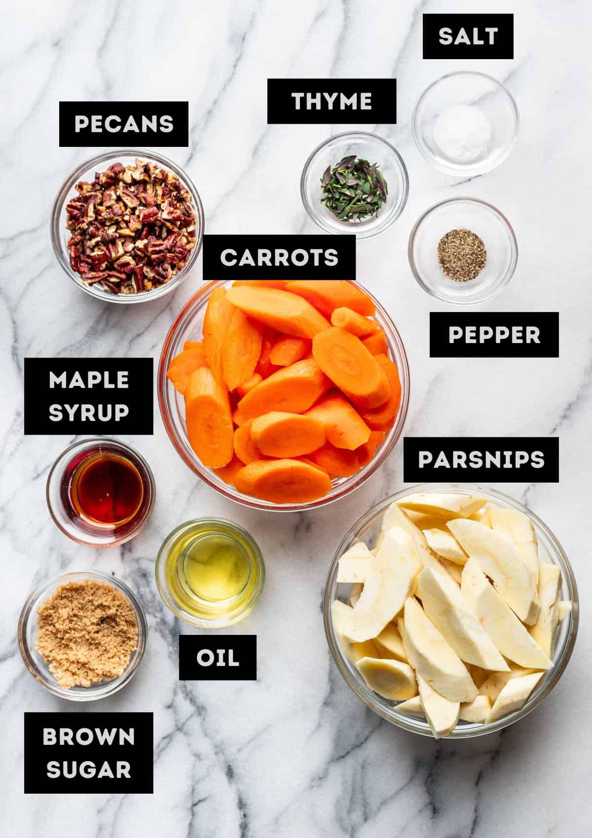 Labelled ingredients for maple roasted carrots and parsnips (see recipe for details).