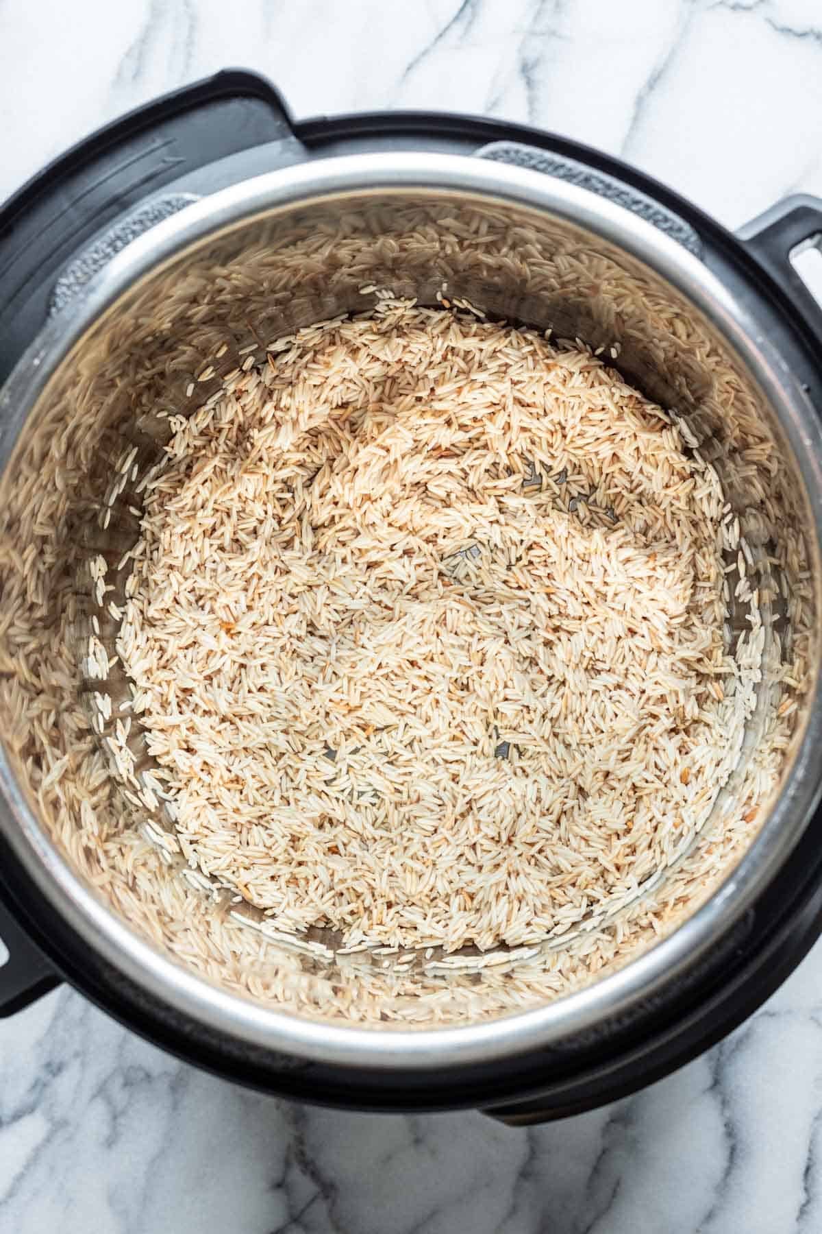 Rice added to an instant pot.
