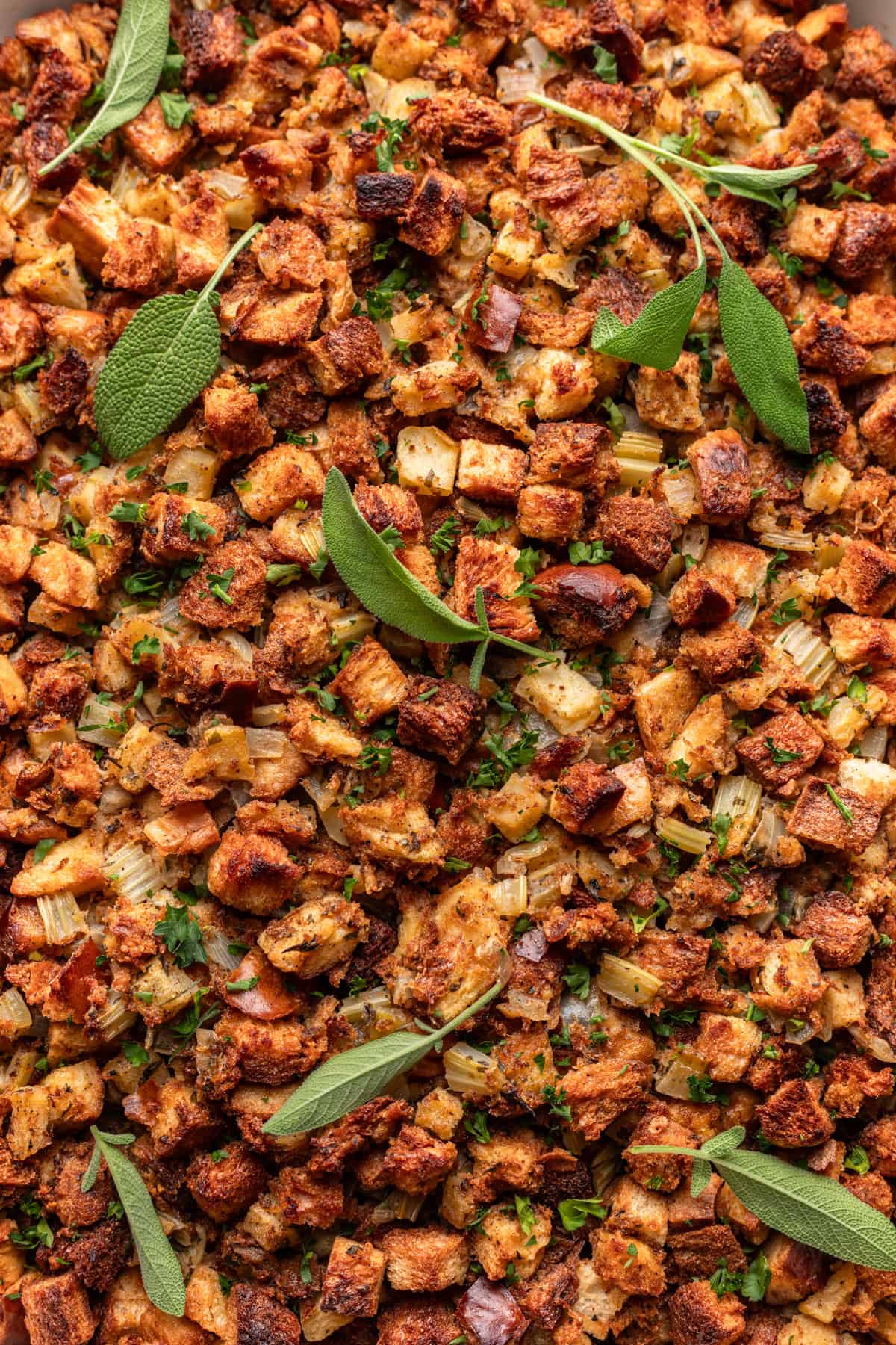 Oven baked challah stuffing with fresh herbs on top.