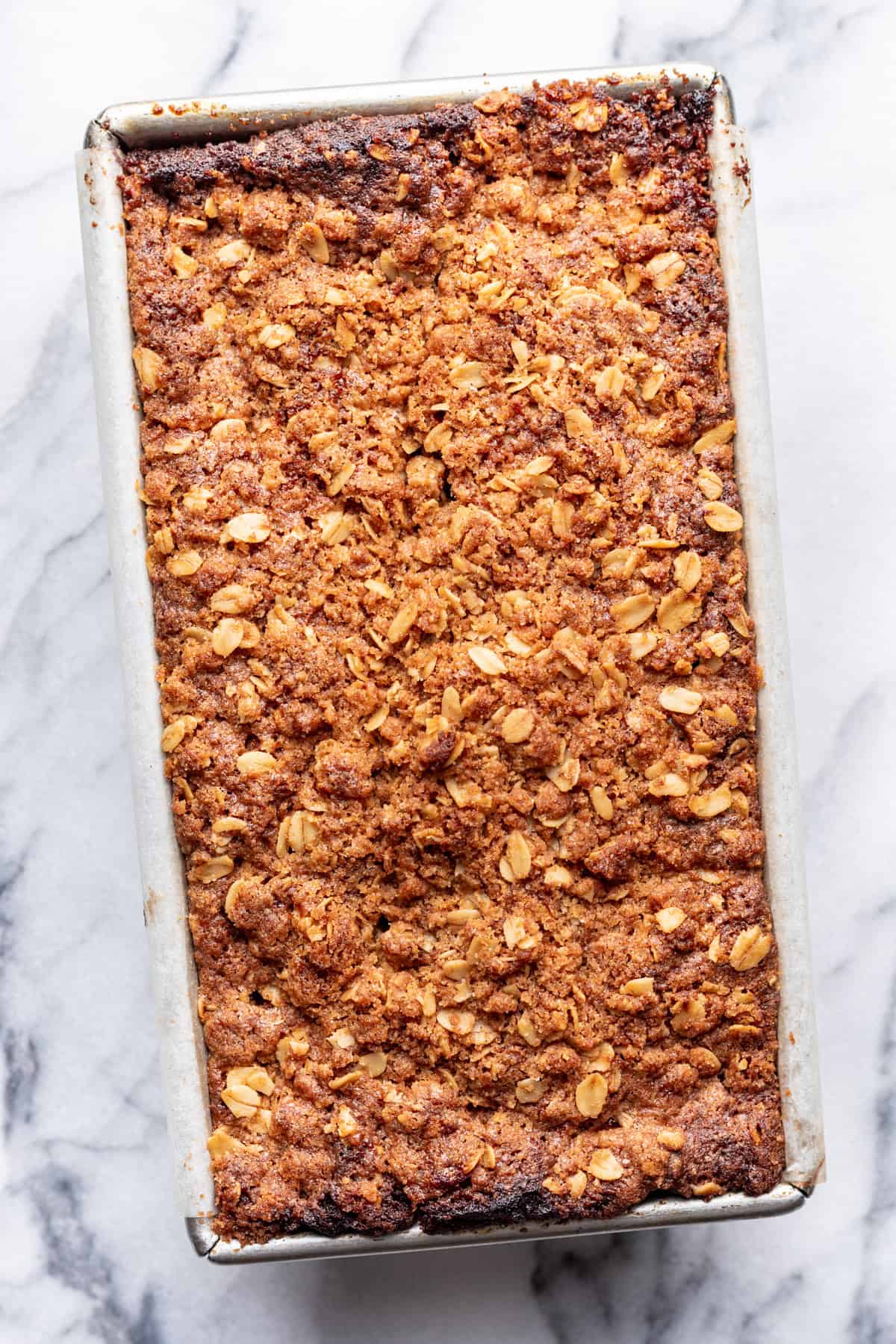 Baked apple banana bread in a loaf pan.