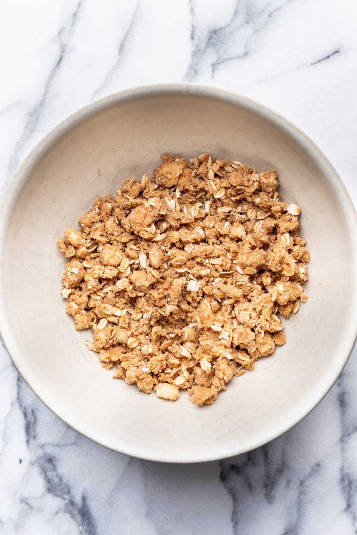 Oat crumble topping in a mixing bowl.