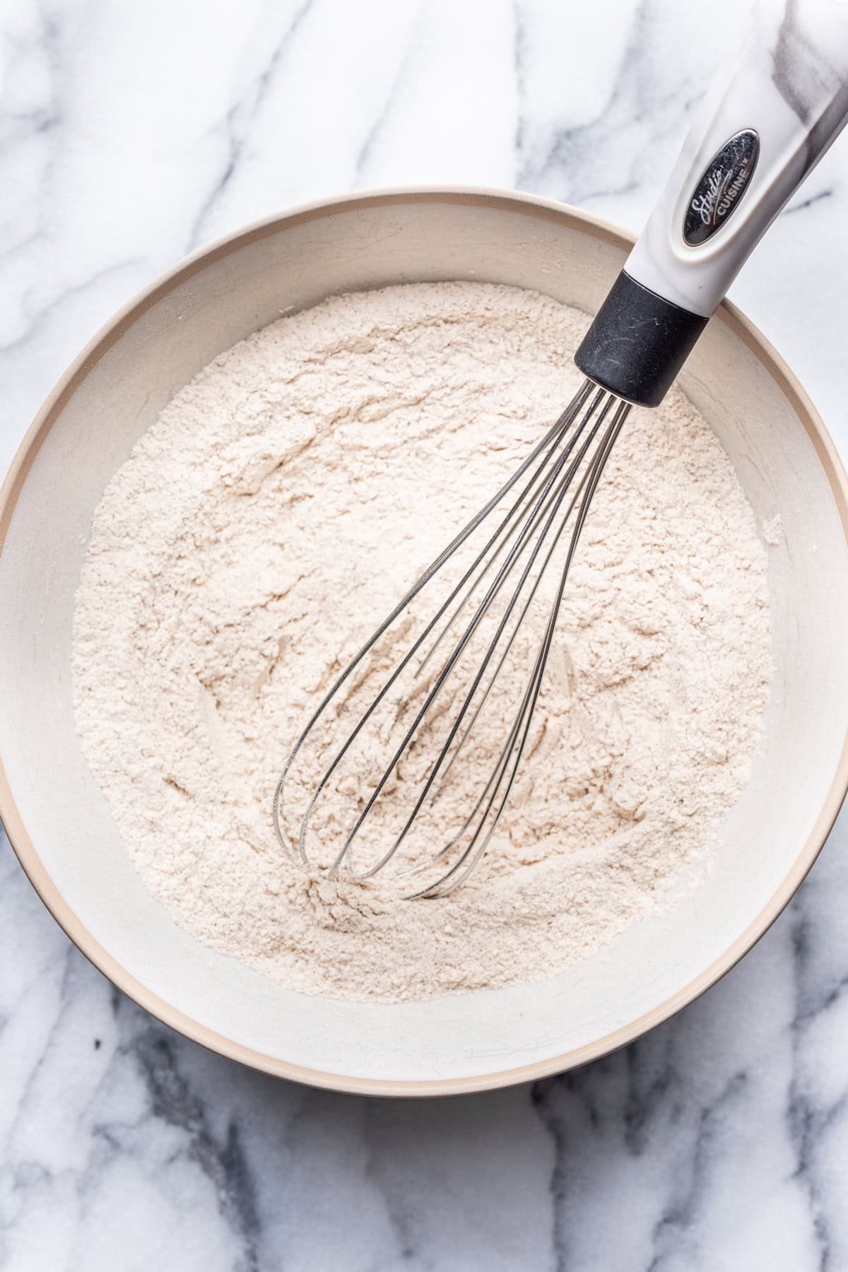 Dry ingredients whisked together in a bowl.