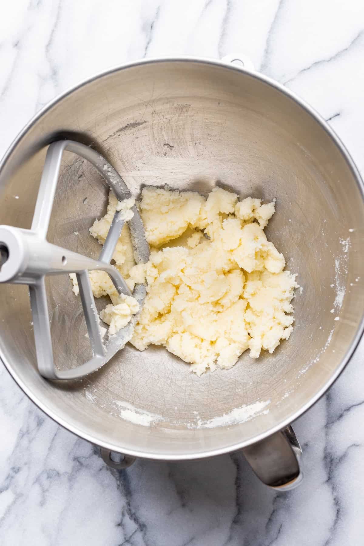 Butter and sugar beaten together in a mixing bowl.