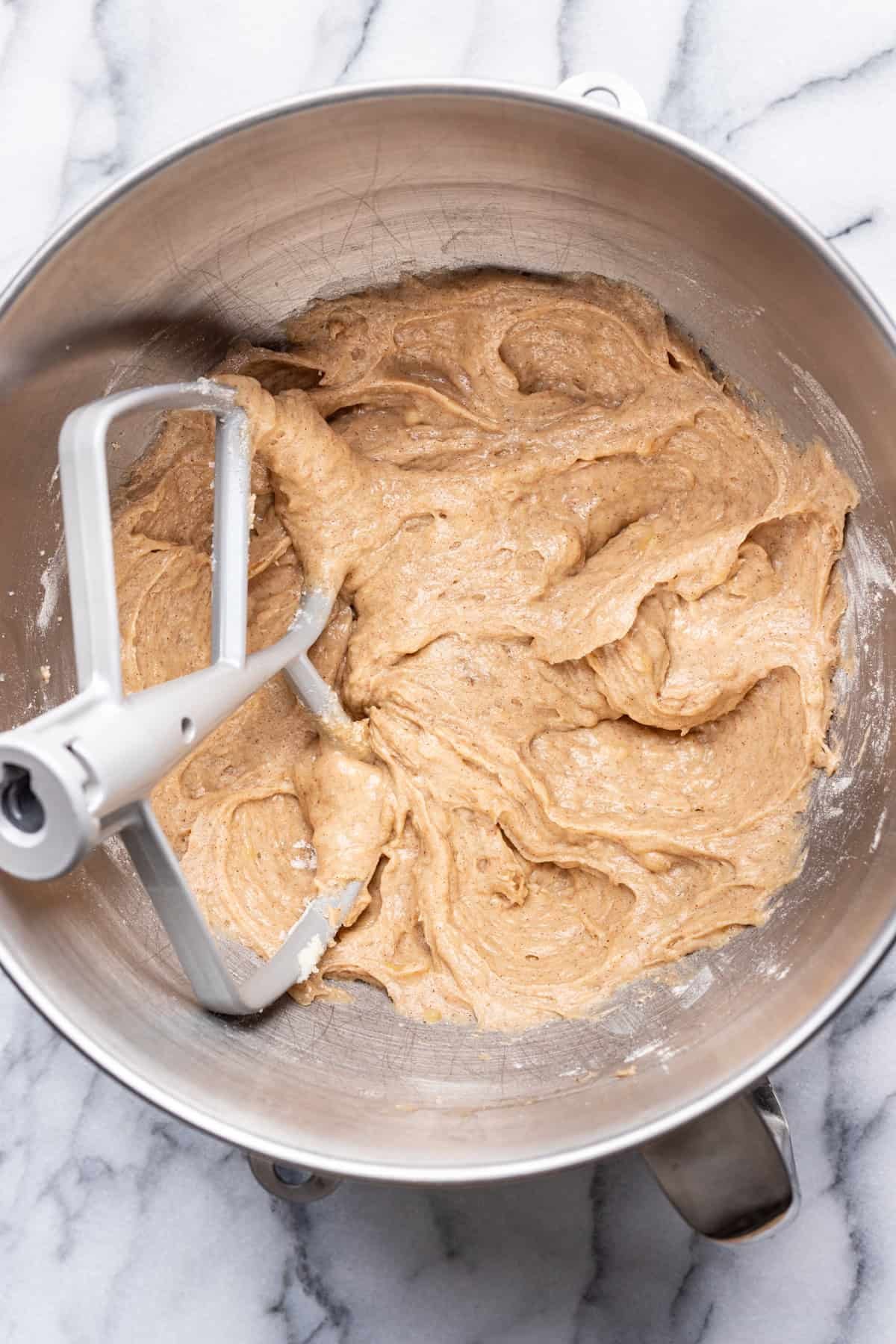 Eggs, vanilla, and flour all mixed together with the butter in a mixing bowl.