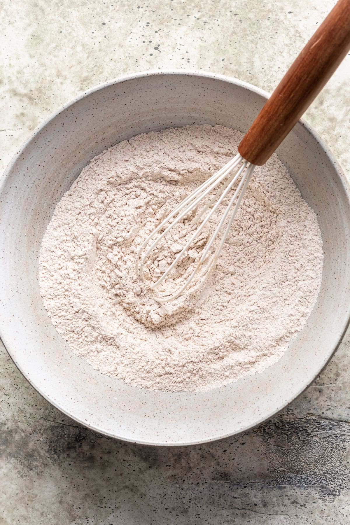 Dry ingredients whisked together in a mixing bowl.