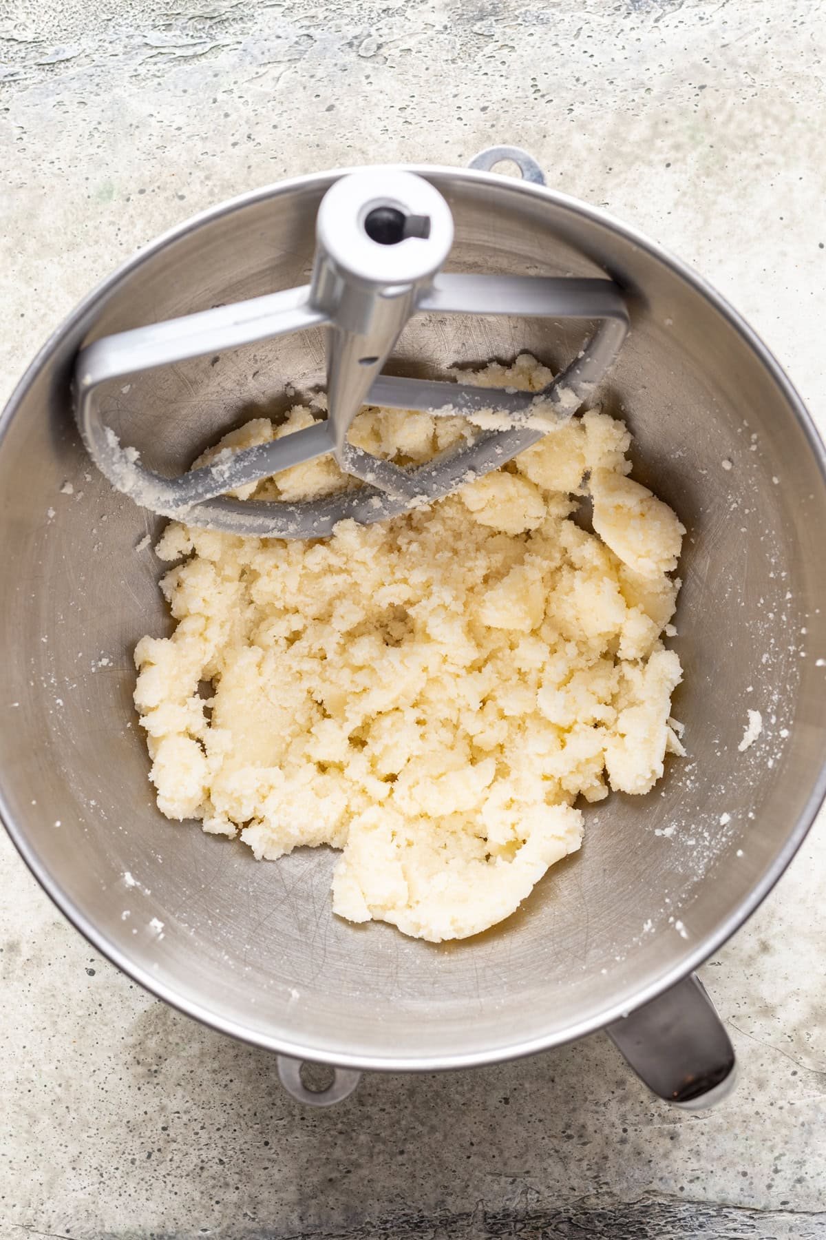 Butter and sugar beaten together in a bowl.