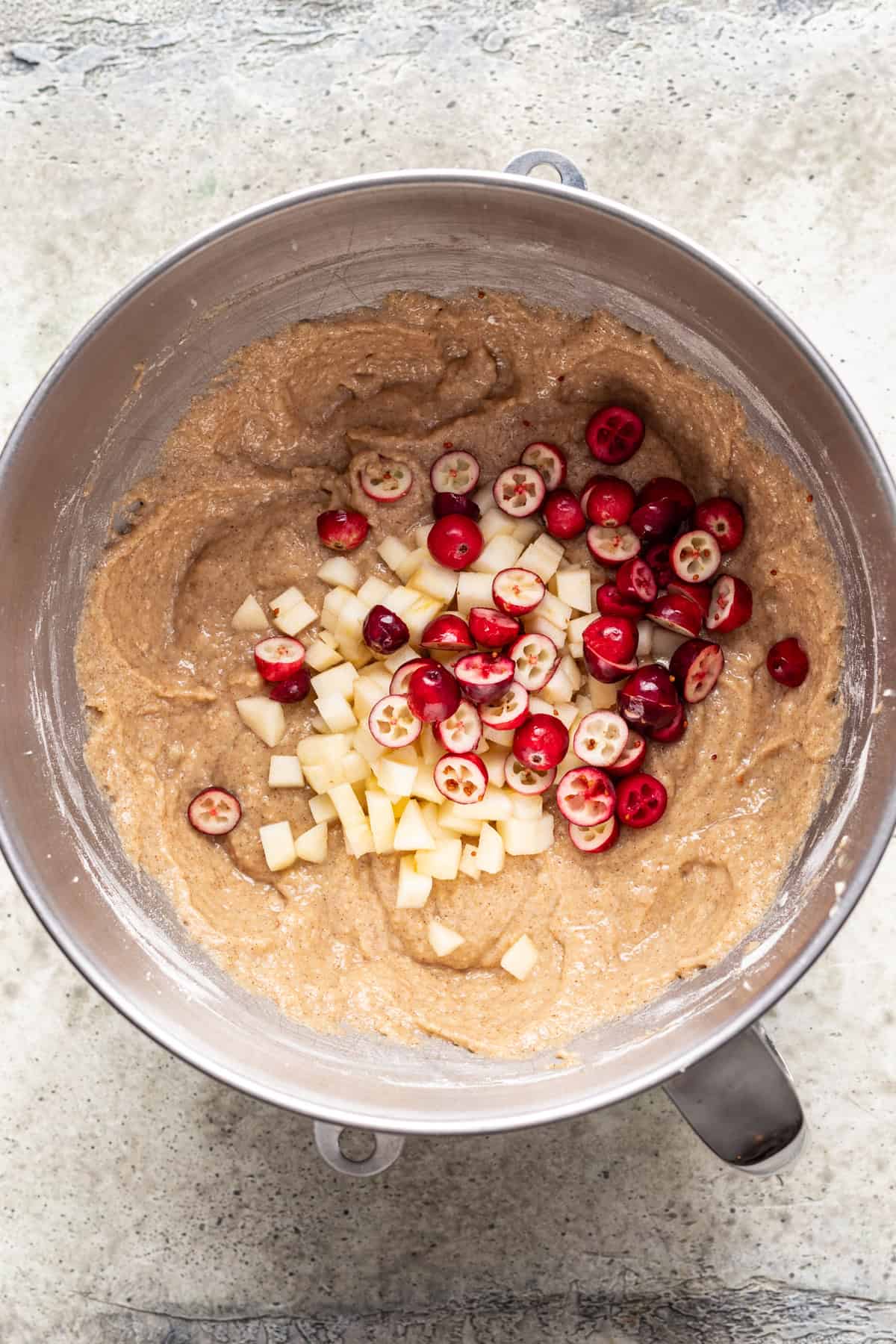 Apples and cranberries added to the bowl with the batter.