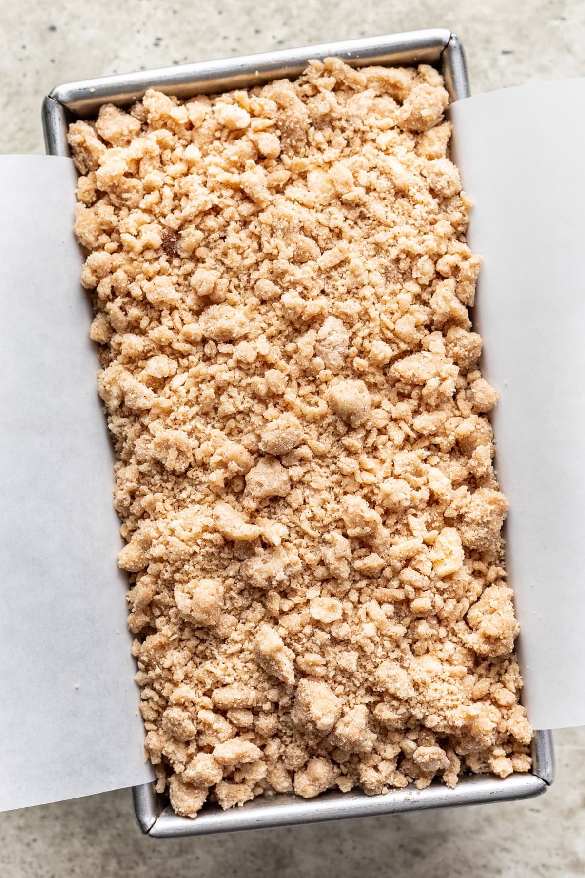 Raw crumb topping and batter in a loaf pan.