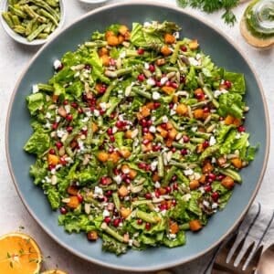 Roasted green bean and butternut squash salad in a blue serving bowl.