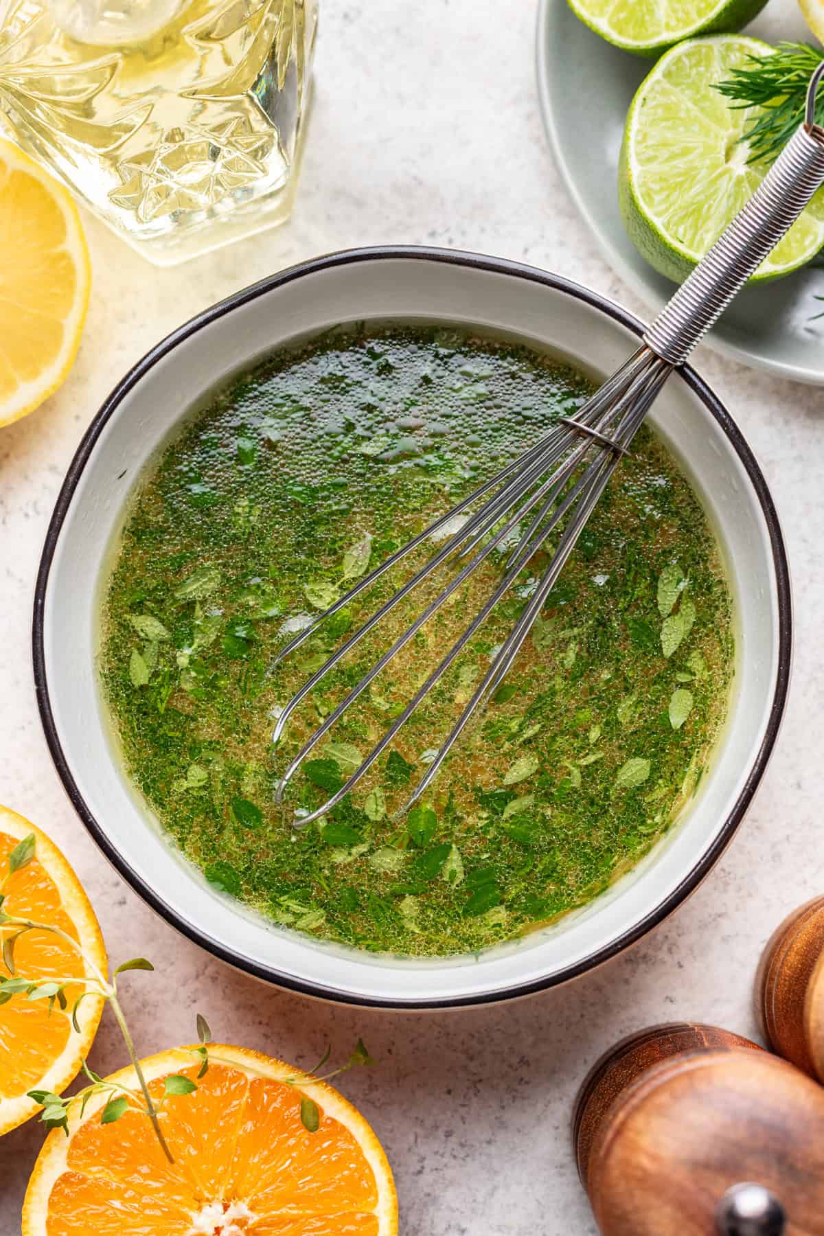 Citrus herb vinaigrette whisked in a bowl.