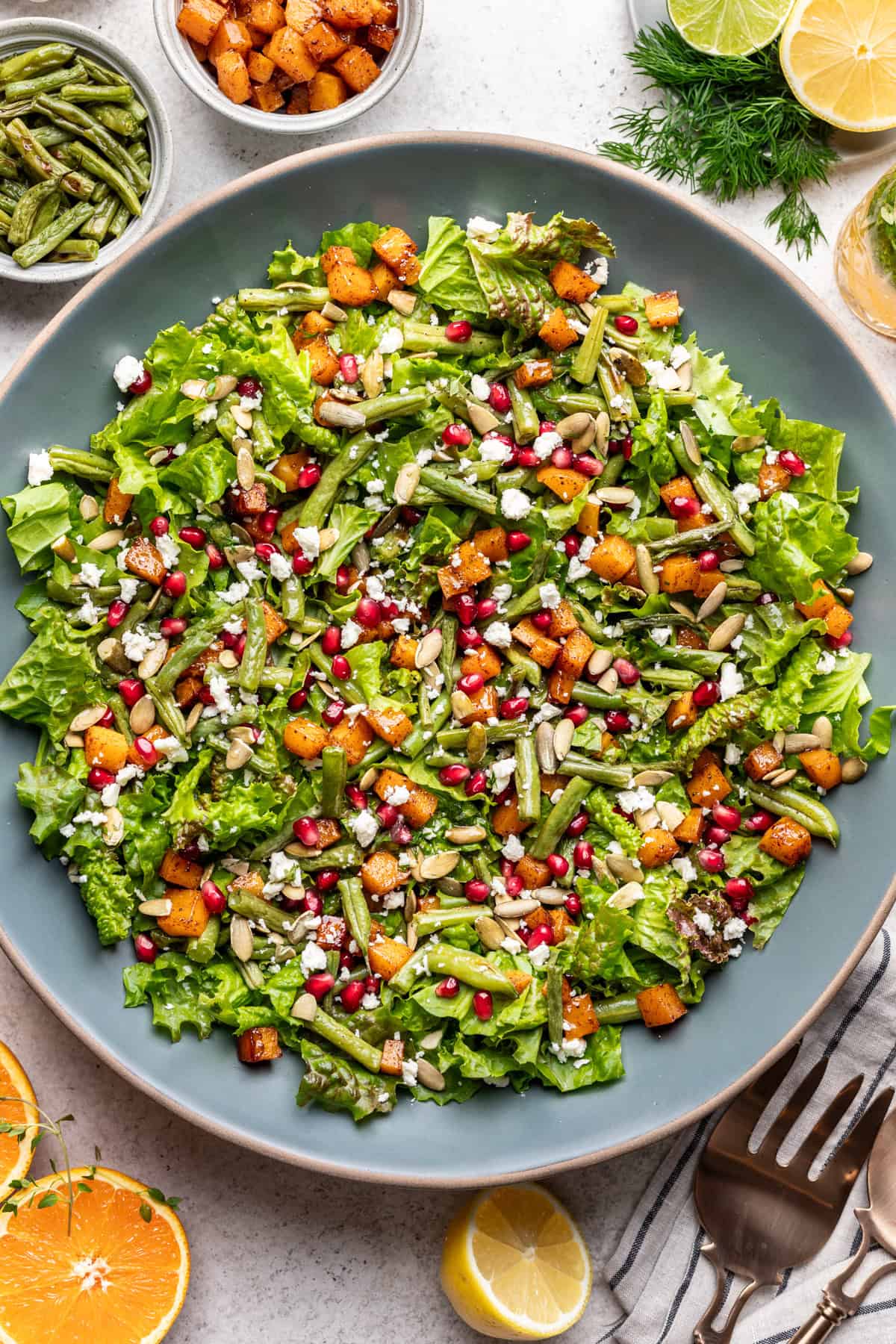 Roasted green bean and butternut squash salad in a large blue serving bowl.