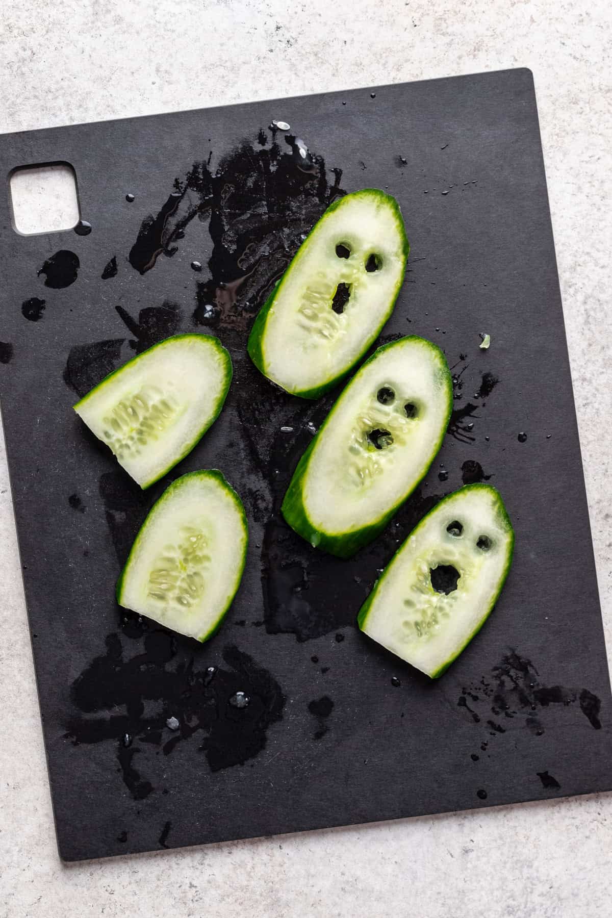 Cucumber slices cut into ghosts.