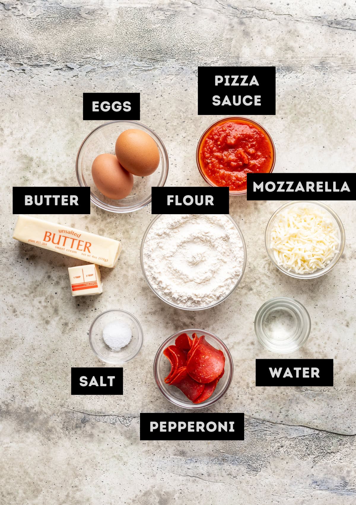 Labelled ingredients for jack o lantern pizza rolls (see recipe for details).