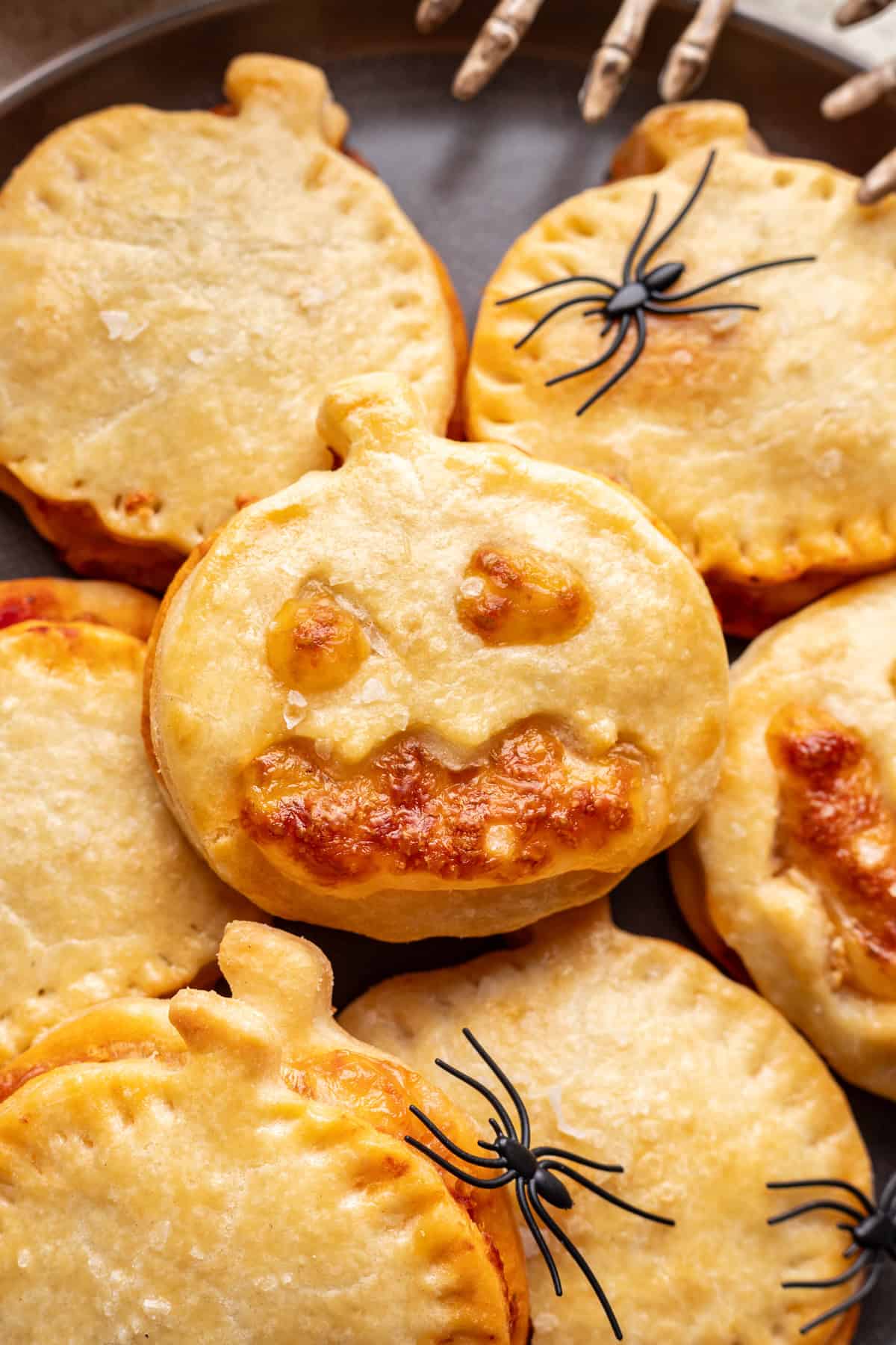 Jack o Lantern Pizza Rolls stacked on top of one another.