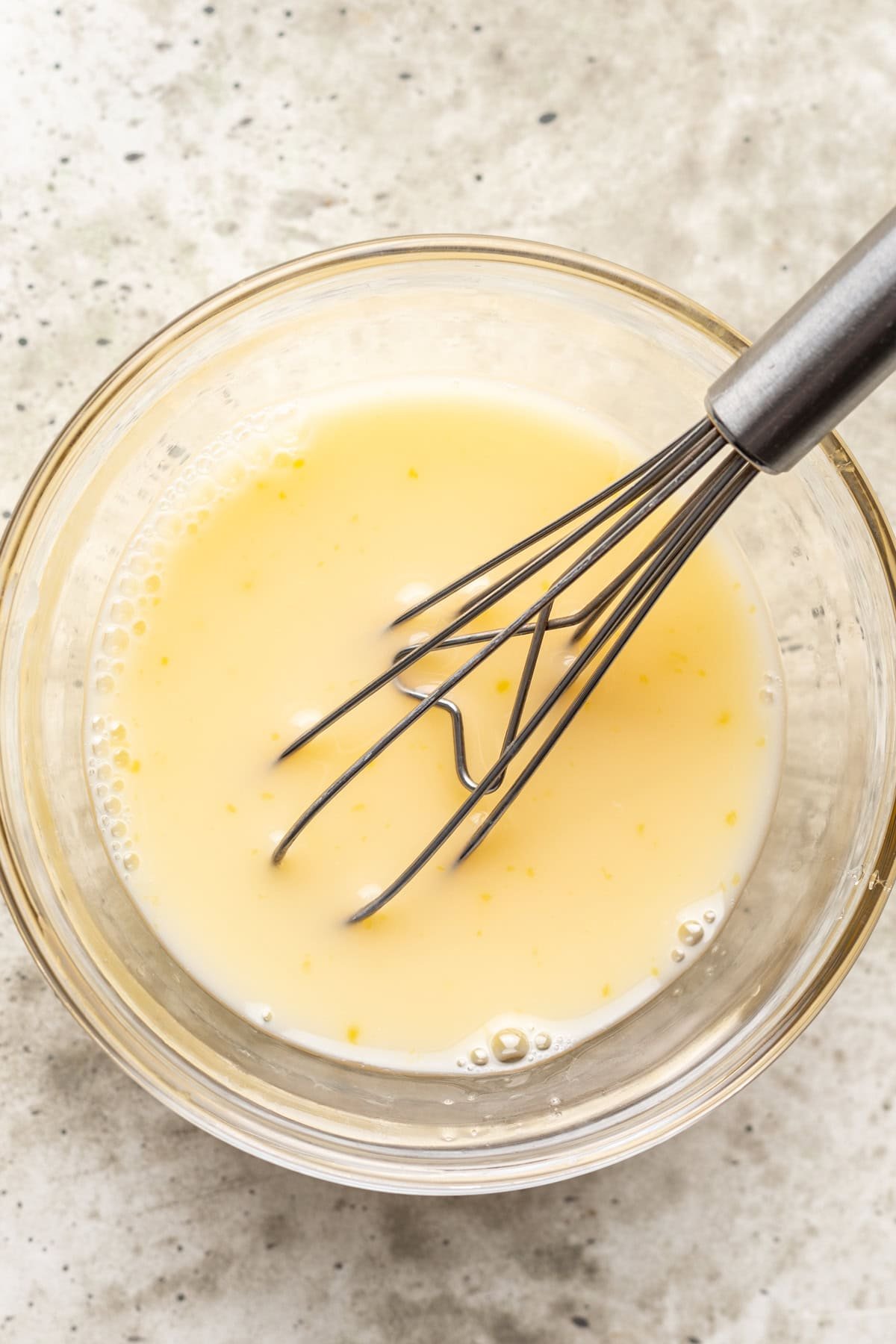 Egg and water whisked together in a bowl.