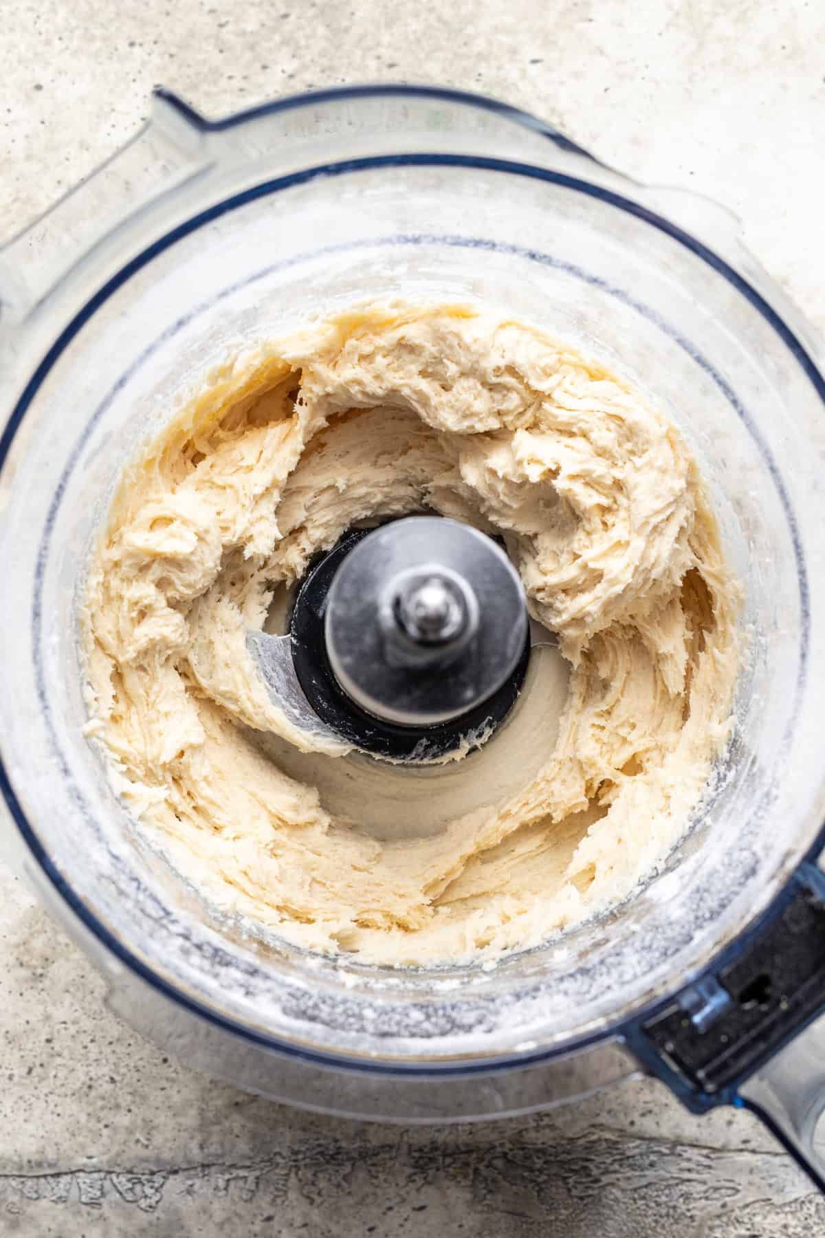 Pizza roll dough mixed in a food processor.