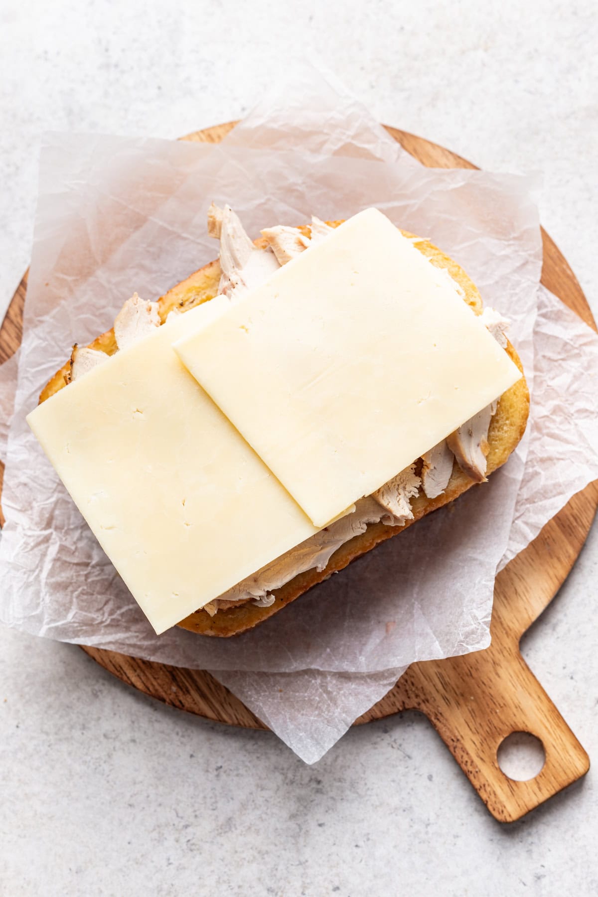 Greens and sliced cheese added on top of the gravy soaked bread.
