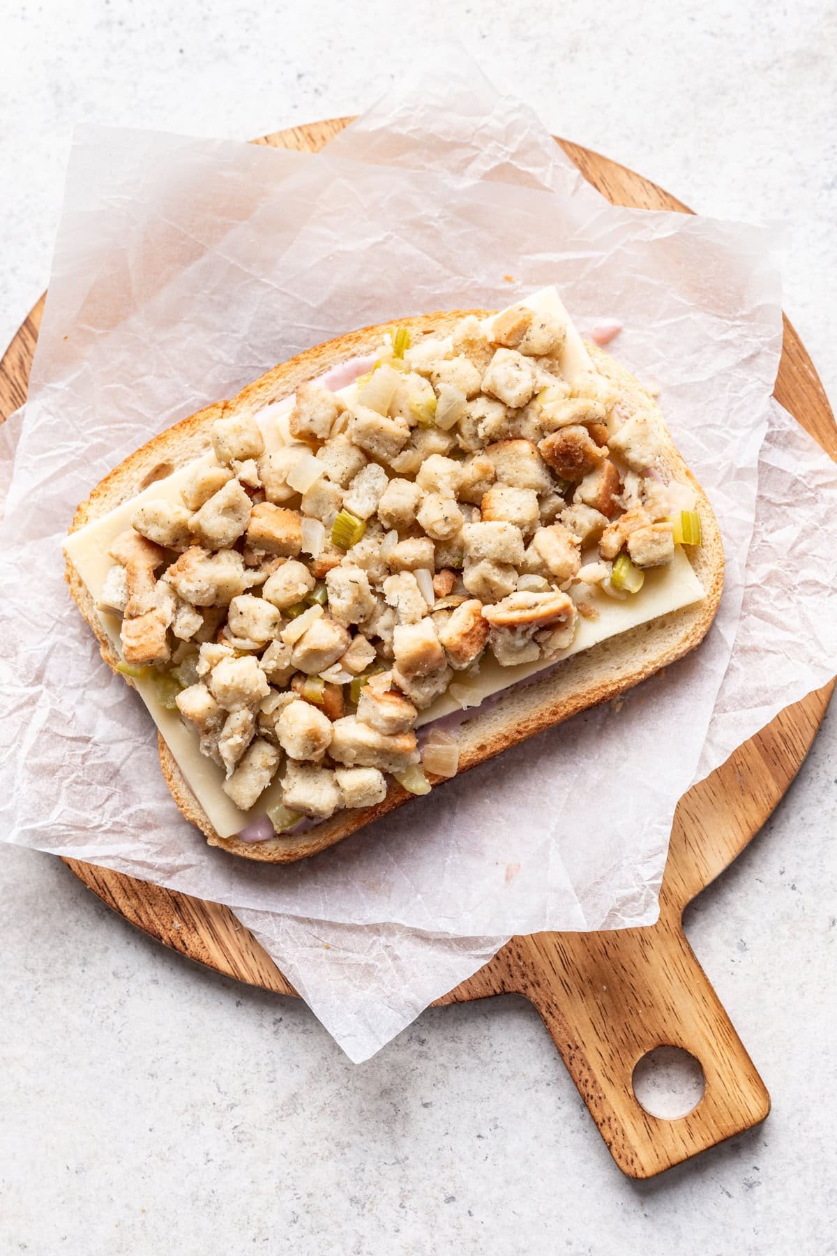 Cheese and stuffing layered next on top of the bread.