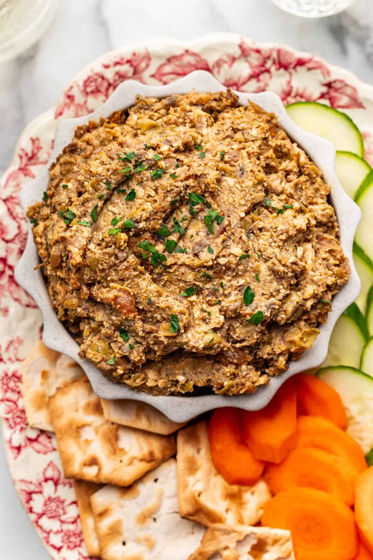 Creamy vegetarian chopped liver in a serving bowl, garnished with fresh parsley.