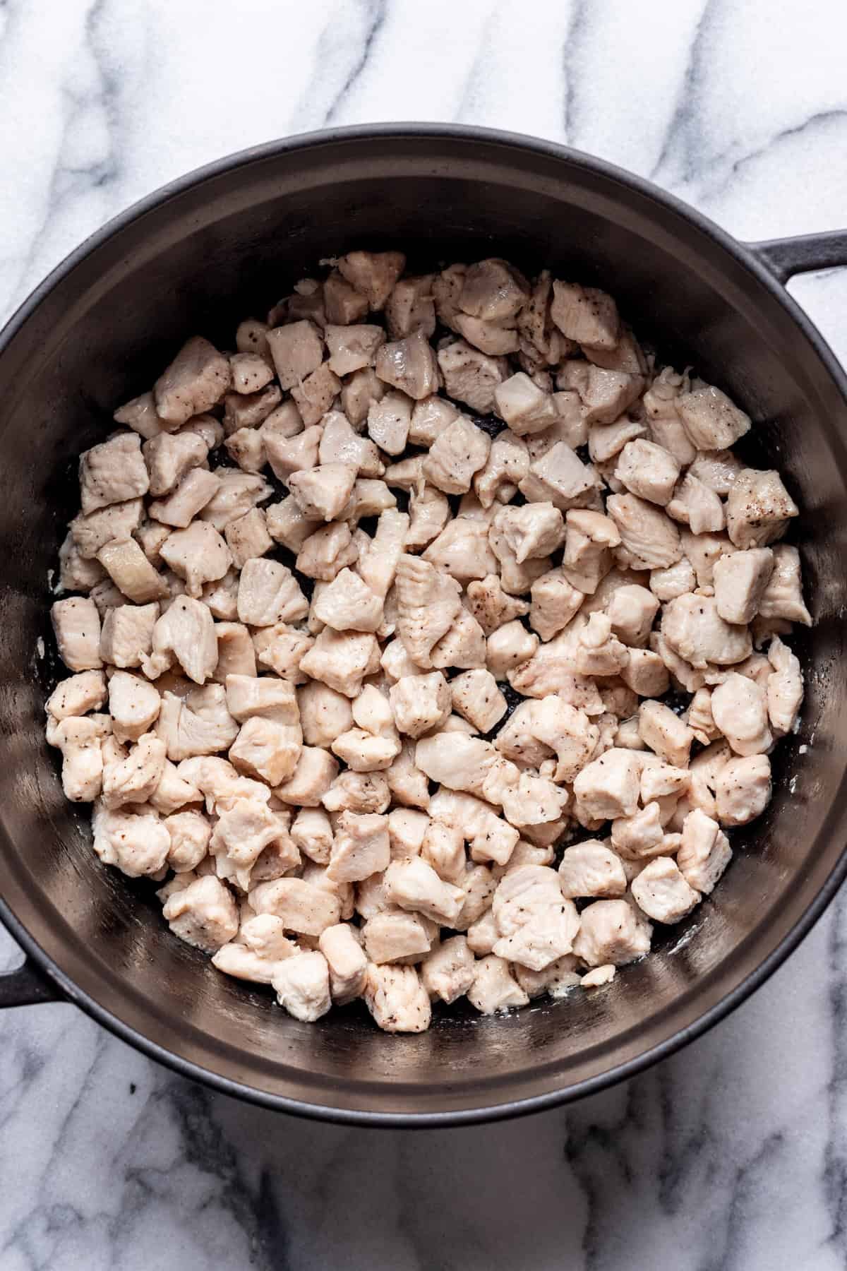 Diced chicken cooked in a large stock pot.
