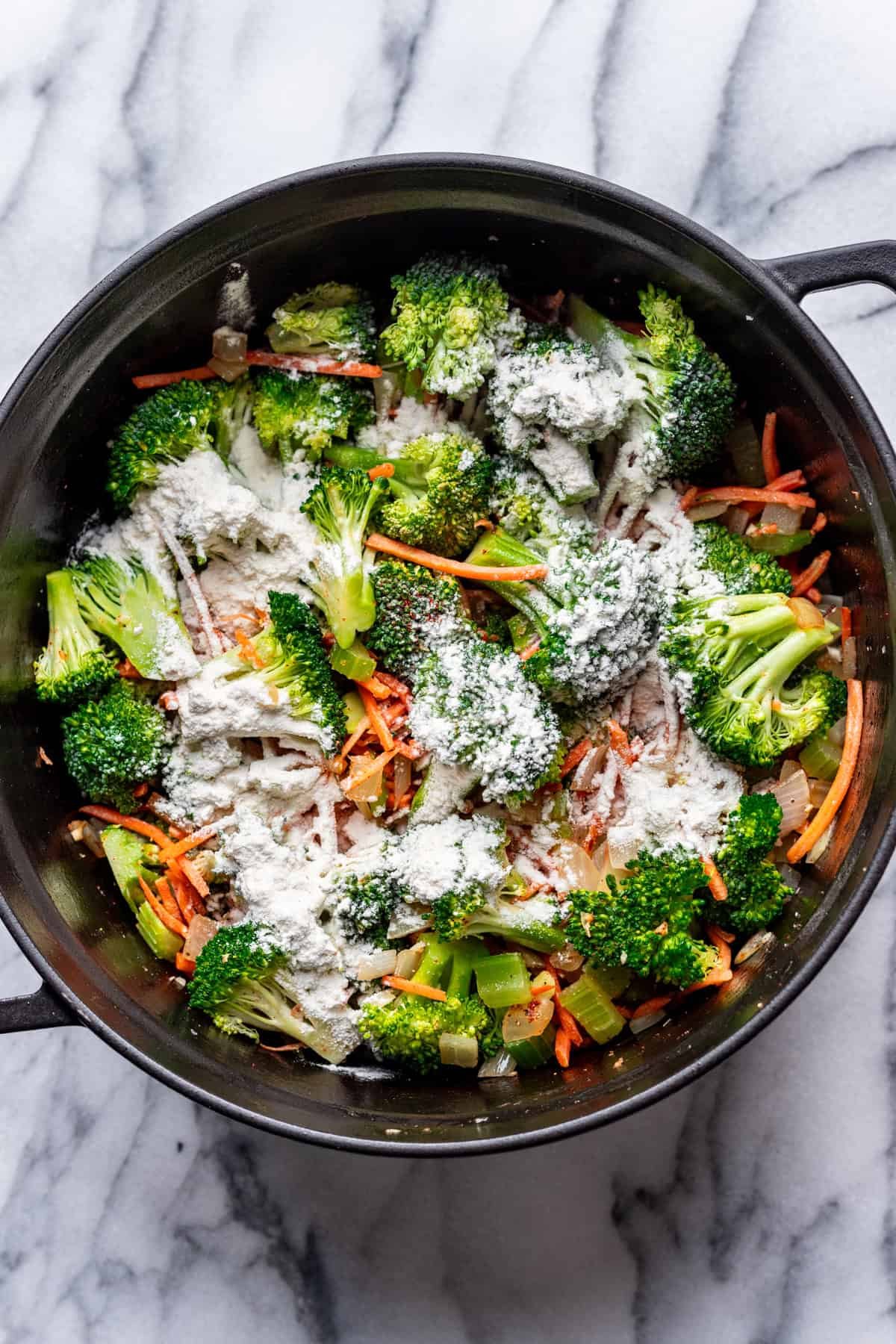 Flour added to the veggies in the pot.