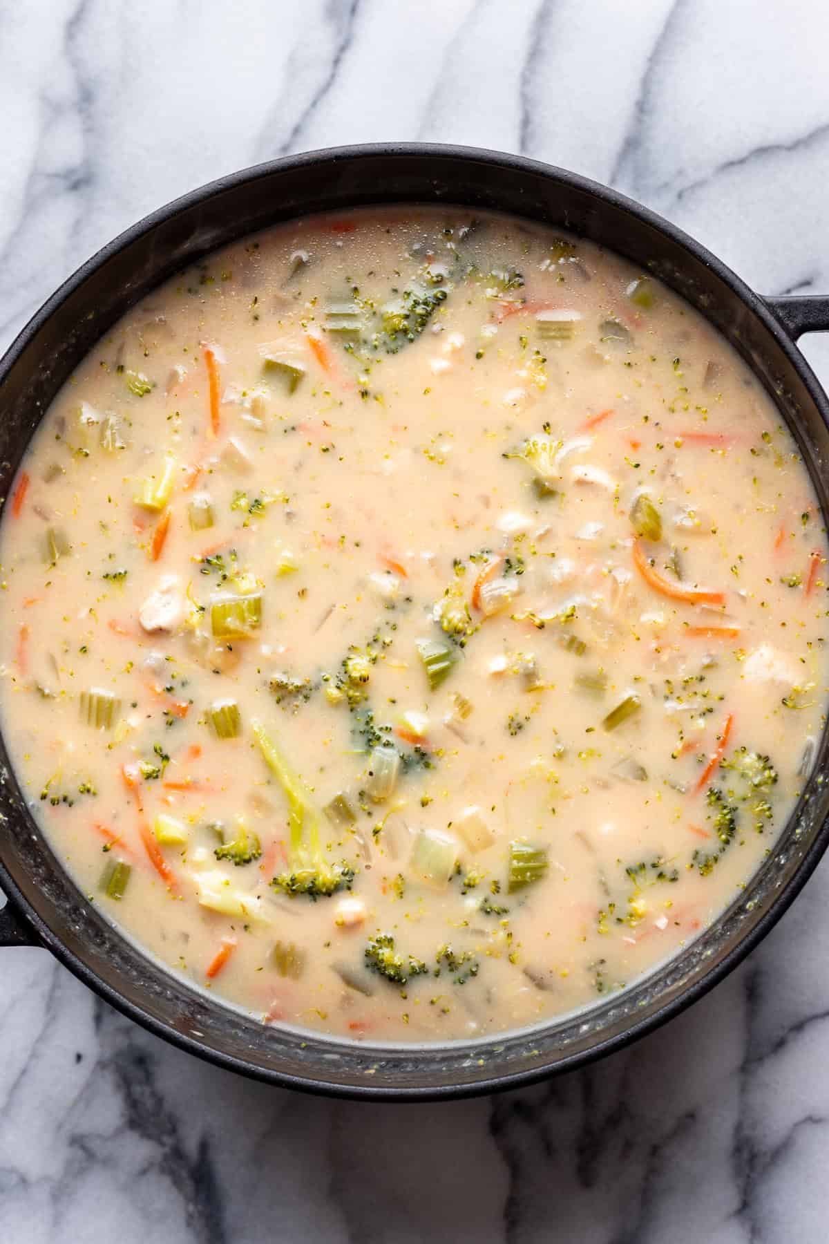 Chicken, milk, and cheese added to the pot.