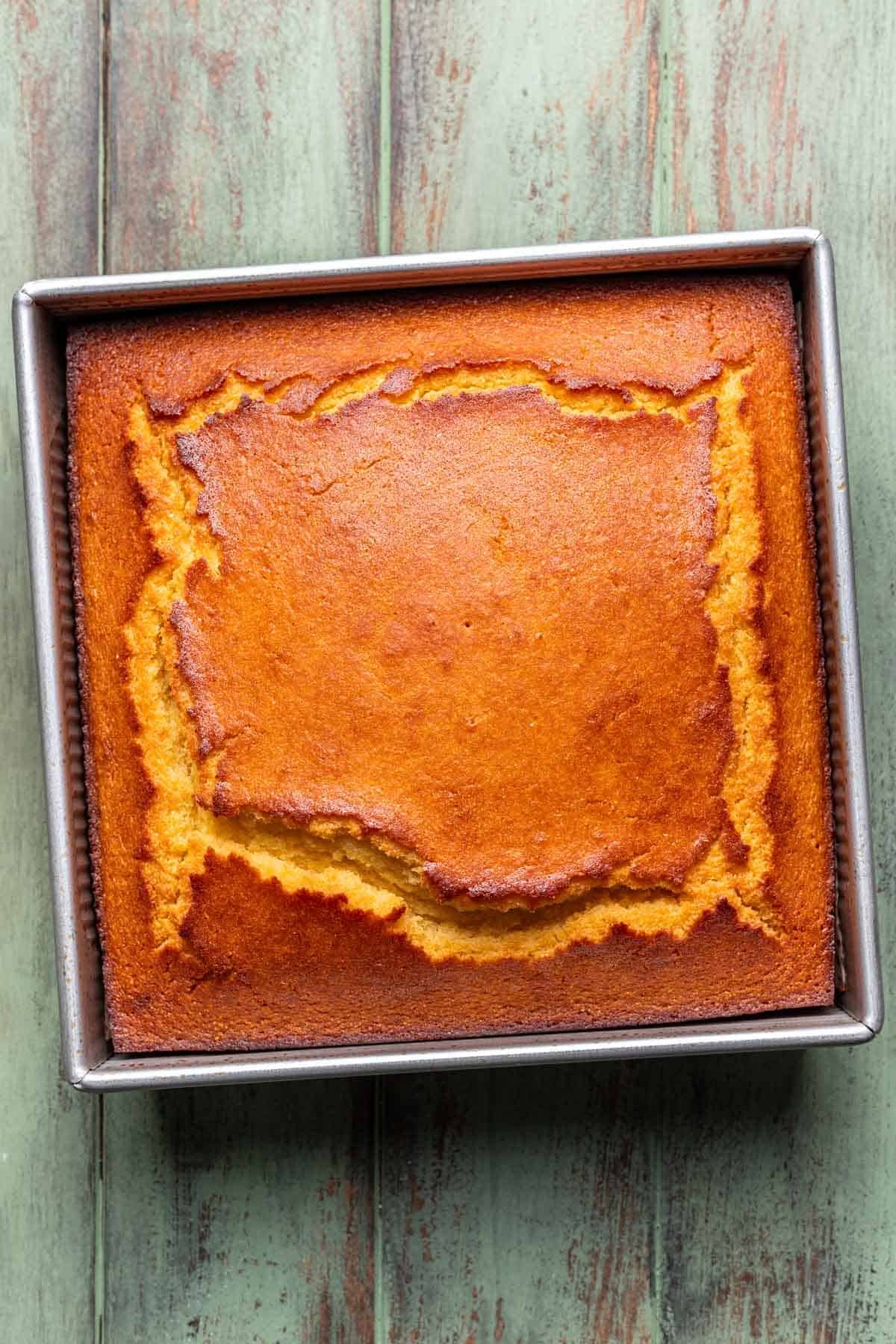 Cornbread baked in a baking pan until golden brown.