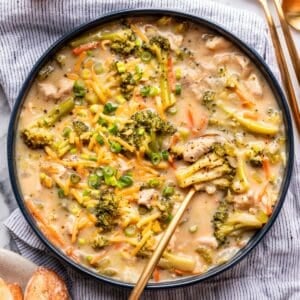 Broccoli cheddar chicken soup in a large bowl with a spoon.