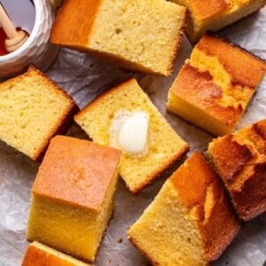 Slices of cornbread with melted butter on top.