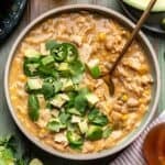 Smoky white chicken chili in a bowl with a spoon.