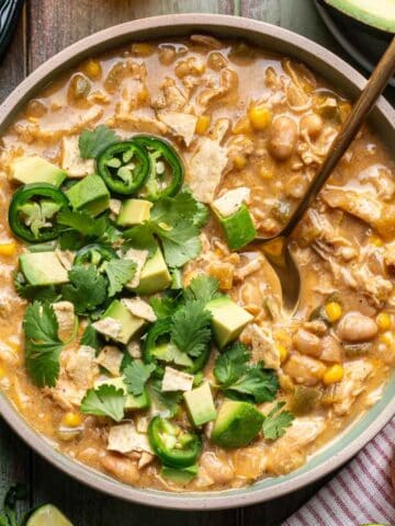 Smoky white chicken chili in a bowl with a spoon.