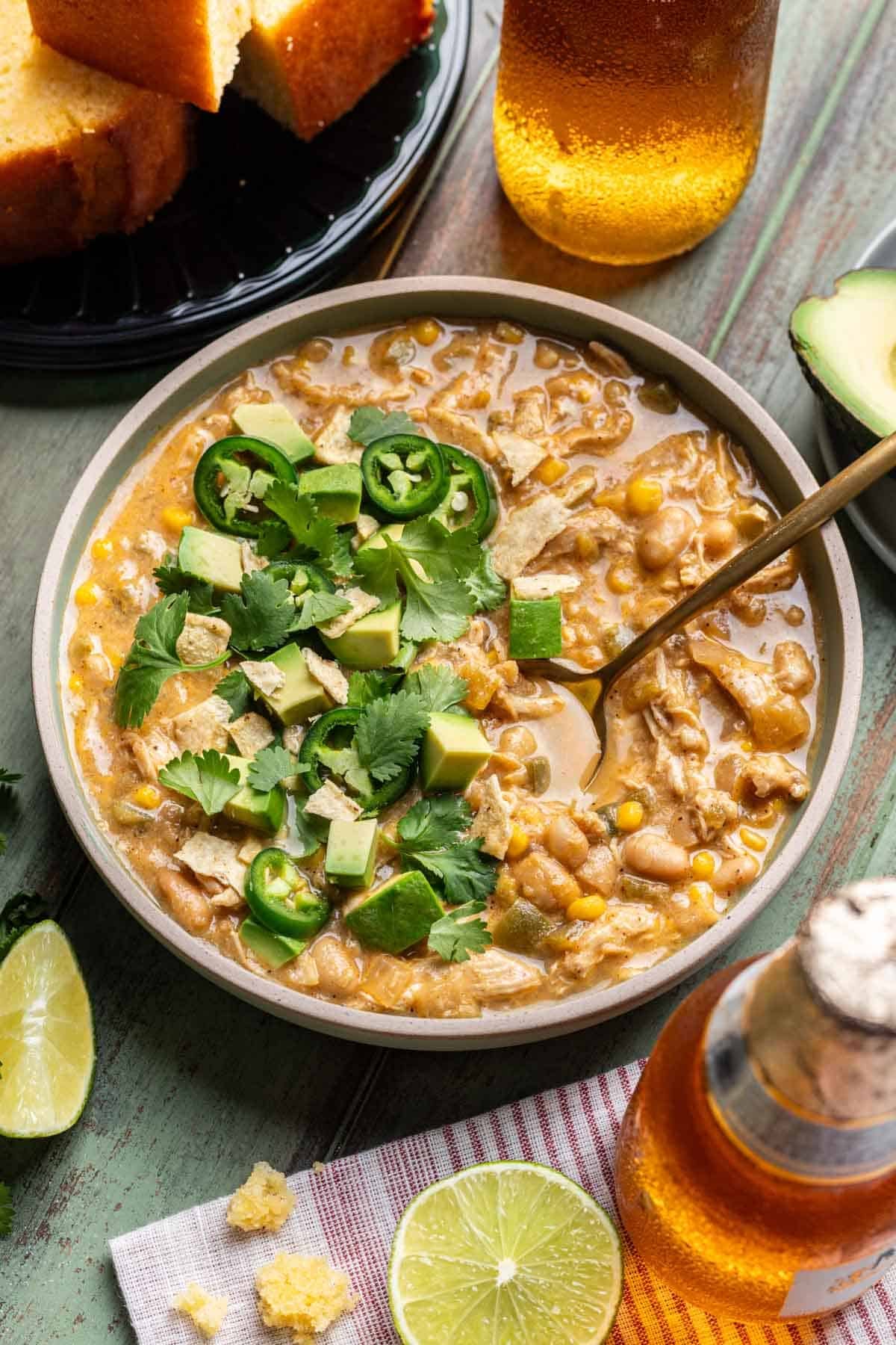 Smoky white chicken chili served with cornbread, beer, and lime wedges.