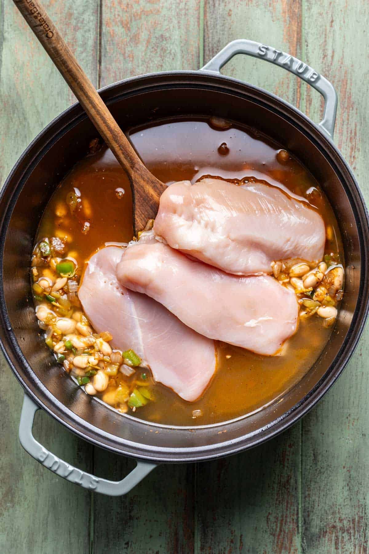 Chicken and broth added to the pot.