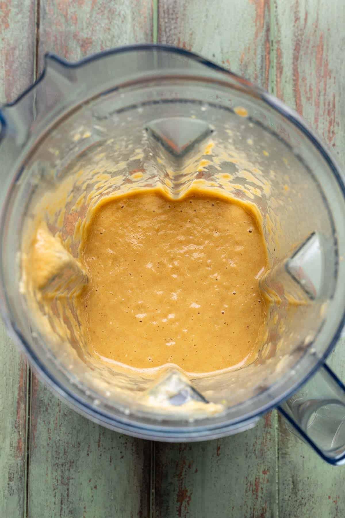 Blended broth, beans, and veggies in a blender.