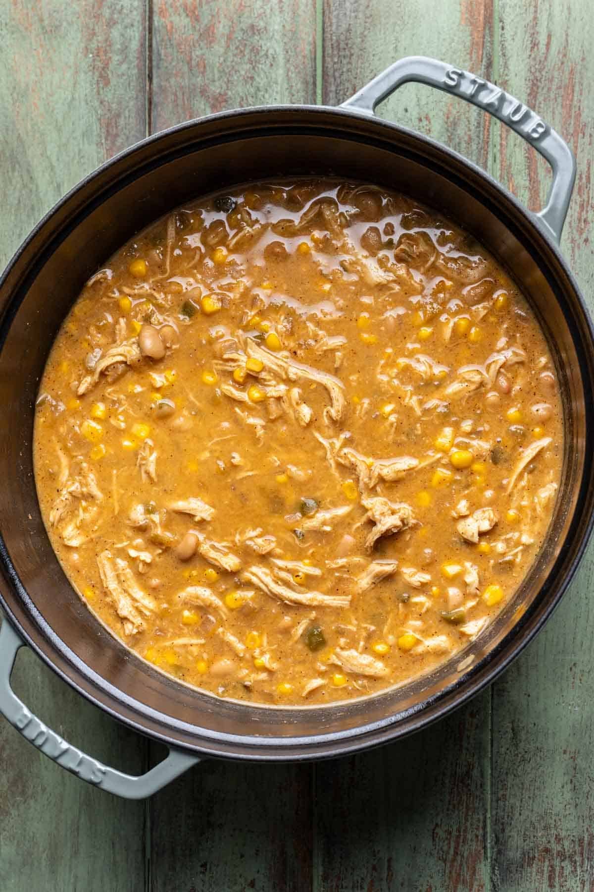 Greek yogurt, blended bean mixture, chicken, corn, and cheese added to the pot.